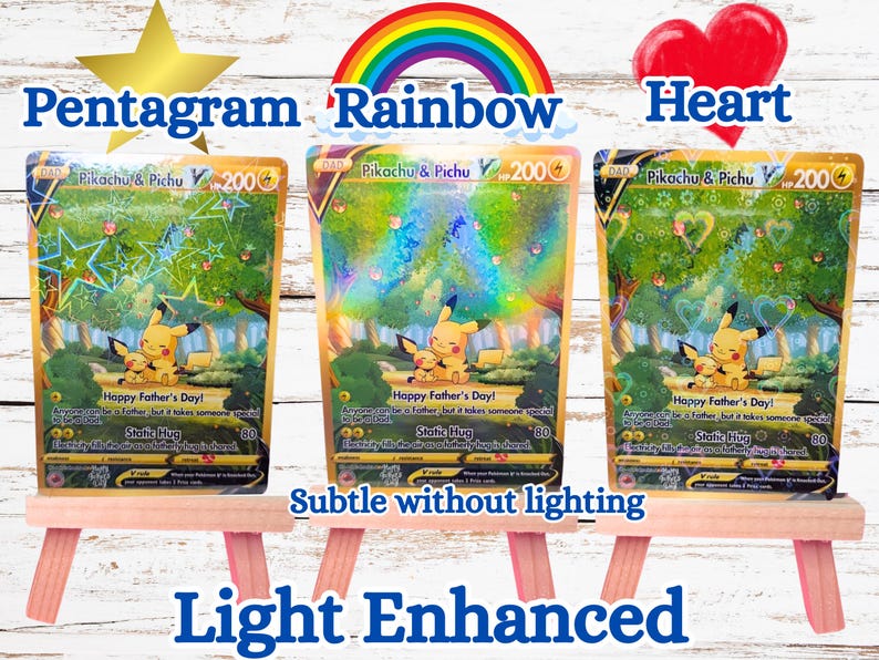 May include: Three Pikachu and Pichu trading cards displayed on small wooden easels. Each card features the characters in a forest, the text Happy Father's Day, Static Hug, and 200 HP. The cards show holographic star, rainbow, and heart patterns.