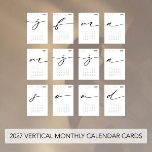 May include: A set of twelve vertical monthly calendar cards for the year 2027. Each white card features a large, black, handwritten-style initial for the month, the full month name, the year 2027, and a grid of dates with SMTWTFS headers.