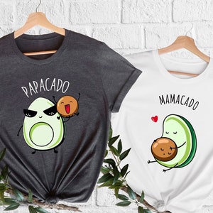 May include: Two gray and white t-shirts with avocado illustrations and the text "Papacado" and "Mamacado".