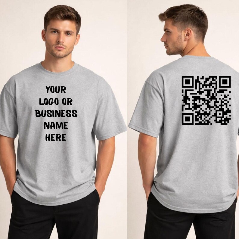 May include: A light gray t-shirt with the text "YOUR LOGO OR BUSINESS NAME HERE" on the front. The back of the shirt features a black QR code. The shirt is short-sleeved and made of a soft material.