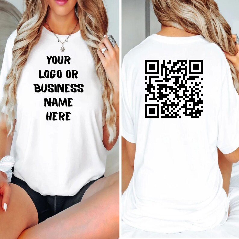 May include: White t-shirt with the text "YOUR LOGO OR BUSINESS NAME HERE" on the front. The back of the shirt features a black QR code. The shirt is a casual style.