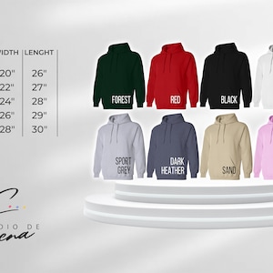 May include: A size chart for hoodies with different colors and sizes. The colors include forest, red, black, white, sport grey, dark heather, sand, and light pink. The sizes are S, M, L, XL, and 2X. The width and length of each size are listed in inches.