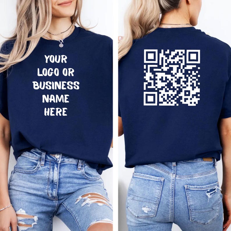 May include: Navy blue t-shirt with the text "YOUR LOGO OR BUSINESS NAME HERE" on the front and a QR code on the back. The shirt is a short-sleeved crew neck style.