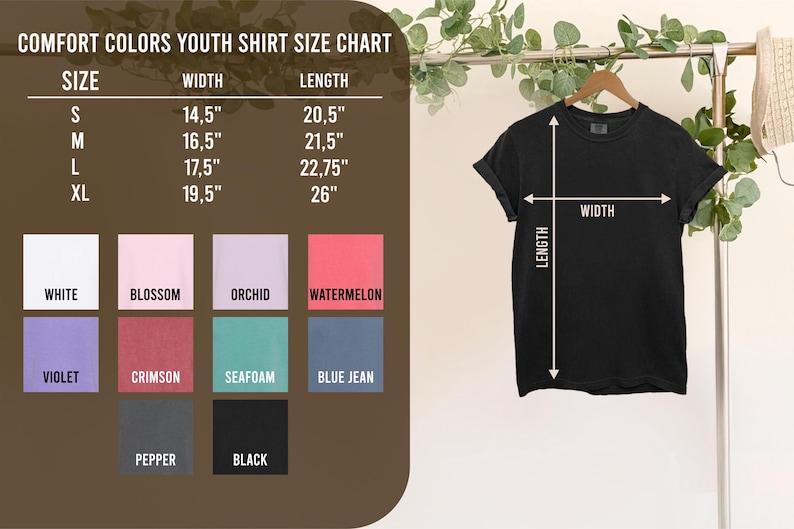 May include: Black Comfort Colors youth t-shirt hanging on a wooden hanger. The shirt's width is measured at 14.5 to 19.5 inches, and the length is 20.5 to 26 inches. A size chart with various colors is displayed.