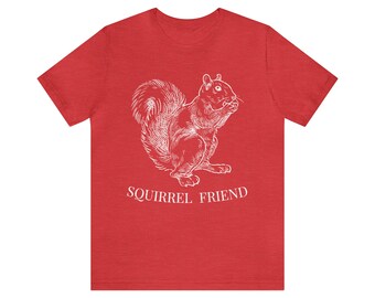May include: Red t-shirt with a white outline of a squirrel holding a nut and the text "Squirrel Friend" below.
