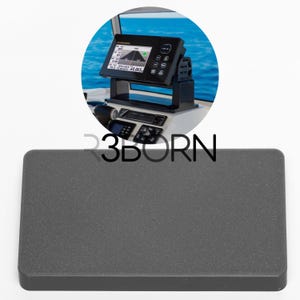 May include: A marine navigation system with a black display screen showing various data, mounted on a white surface. The system is set against a backdrop of blue water and sky. A dark grey rectangular object is in the foreground, with the text "3BORN".