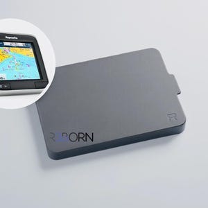 May include: A grey electronic device with the text "R PORN" printed on it. A smaller inset image shows a marine navigation device displaying a map. The device has a black screen and silver trim.