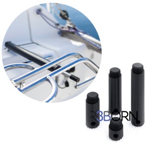 May include: Three black metal boat cleats with a threaded hole on the bottom. The cleats are designed to be used on a boat or other watercraft.