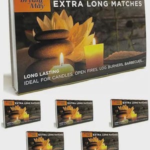 May include: A rectangular box of Bryant & May Extra Long Matches featuring a graphic of stacked dark stones, a yellow lotus flower, and a lit candle. The black packaging includes the text "LONG LASTING" and "IDEAL FOR CANDLES, OPEN FIRES, LOG BURNERS, BARBECUES".