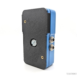 May include: A blue and black electronic device with two silver jacks on the side. The device has a black rubber cover on the back.