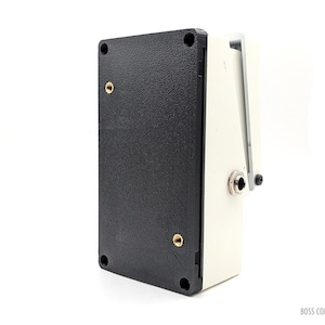 May include: A black and white BOSS COMPACT guitar effects pedal. The pedal has a textured black base with gold screws and a white side with a jack input. The pedal is designed for use with electric guitars.