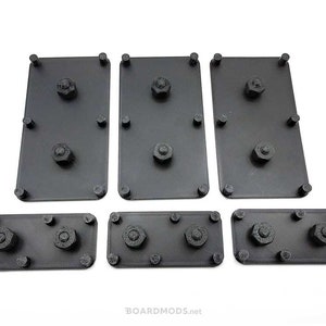 May include: Set of seven black plastic plates with raised circles. The plates are designed to hold small objects, such as screws or nuts.