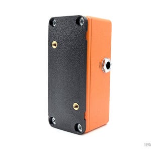 May include: A black and orange compact guitar effects pedal with a single output jack labeled "OUT".
