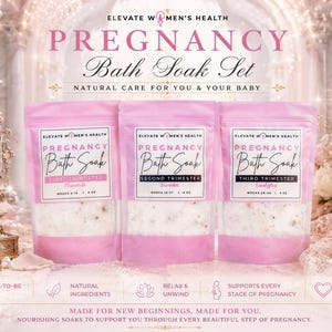 May include: Pink bath soak set for pregnancy, featuring three pouches labeled for each trimester. The pouches have white and pink sections with text. The image includes a decorative mirror, flowers, and a lit candle.