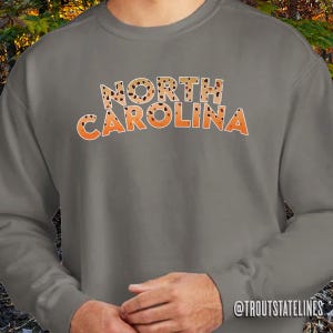 Comfort Colors Sweat
Fly Fishing Shirt
NC Vacation Apparel
NC Travel Sweatshirt
Trout Sweatshirt
North Carolina Trout
Soft Cotton Sweats
NC Brook Trout
NC Travel Souvenir
Trout Fishing Shirt
Comfy Sweatshirt NC
Carolina Brown Trout
Carolina Fishing