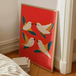 May include: A framed print with a red background and four white birds with yellow and green accents. The birds are flying in different directions.