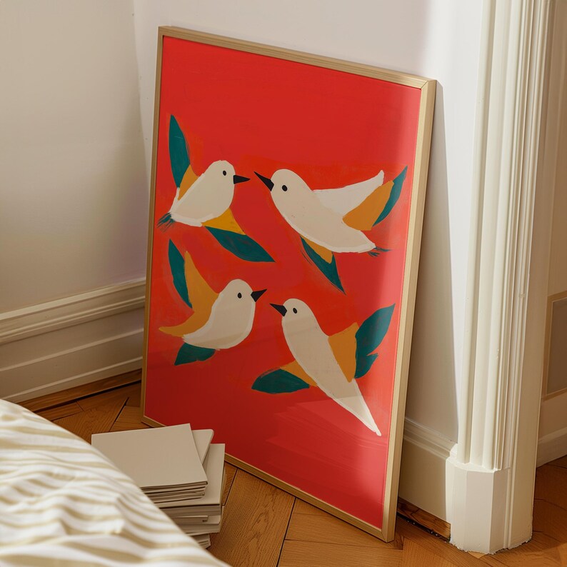 May include: A framed print with a red background and four white birds with yellow and green accents. The birds are flying in different directions.