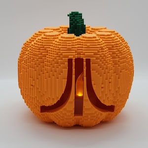 Calabaza pixelada de Halloween con el logotipo de Atari: arte, decoración de estanterías y sala de juegos
