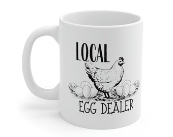 May include: White ceramic mug with a black and white illustration of a chicken and the text "LOCAL EGG DEALER".