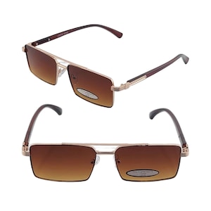 May include: A pair of brown rectangular sunglasses with a gold metal frame. The sunglasses have a brown polycarbonate lens and a brown plastic arm.