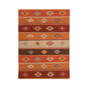 May include: A rectangular rug with a striped pattern in shades of orange, brown, and beige. The rug features repeating geometric designs in various colors, including blue, yellow, and red. The rug is suitable for indoor use.