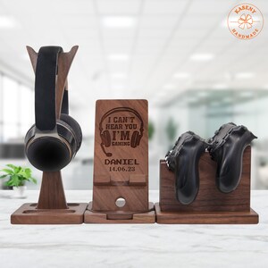 May include: Wooden stand with three compartments for organizing gaming accessories. The stand has a phone holder with the text "I can't hear you I'm gaming" and a personalized name and date.