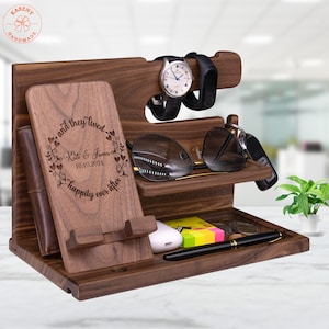 May include: A wooden organizer with a phone stand, watch holder, glasses holder, and a small tray. The organizer is engraved with the text "and they lived, Kate & James, 10.10.2024, happily ever after".