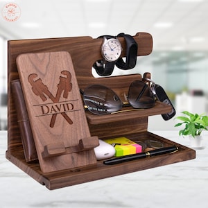 May include: A wooden organizer with multiple compartments for holding various items, such as a phone, watch, sunglasses, and keys. The organizer is personalized with the name "DAVID" and a design of two crossed wrenches.