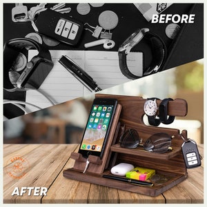 May include: A wooden organiser with compartments for a phone, watch, keys, and other small items. The organiser is made of dark wood and has a natural finish. The organiser is shown on a wooden surface.