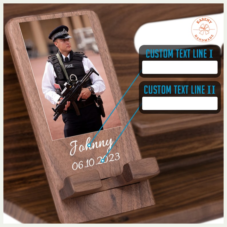 May include: Wooden phone stand with a photo of a police officer, the name "Johnny", and the date "06.10.2023" printed in white. Features two lines for custom text. The stand is made of dark wood.