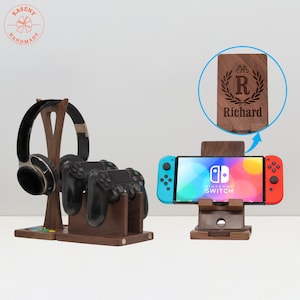 May include: Wooden gaming accessories set. Includes a headphone stand, controller stand, and a Nintendo Switch stand. The Switch stand has a personalized engraving with the name "Richard" and a decorative wreath.