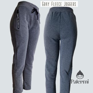May include: Gray fleece joggers with a drawstring waistband and side pockets. The joggers have the text "SPORT18" printed on the side.