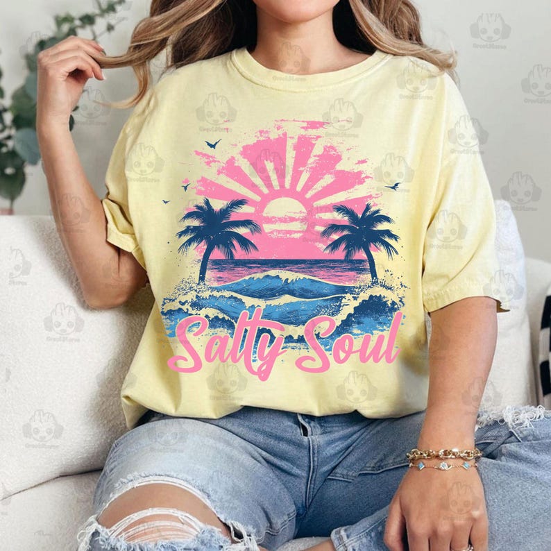May include: A yellow t-shirt with a graphic of a sunset over a beach with palm trees and the text "Salty Soul".