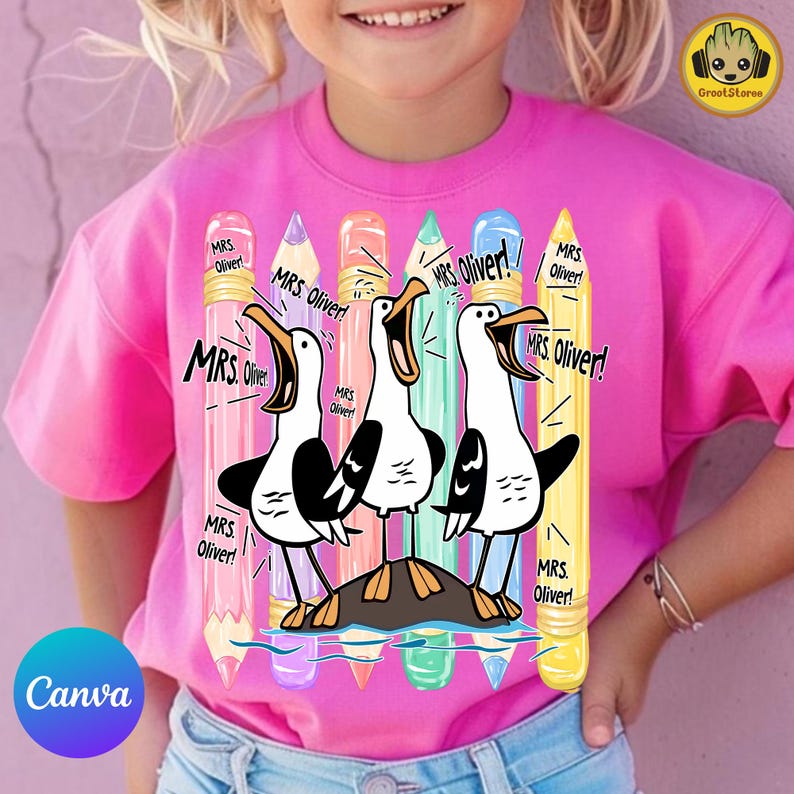 May include: A bright pink t-shirt featuring a graphic print of three cartoon seagulls standing on a rock. Behind the birds are six vertical colored pencils in pink, purple, orange, teal, blue, and yellow. The text "MRS. Oliver!" appears repeatedly.