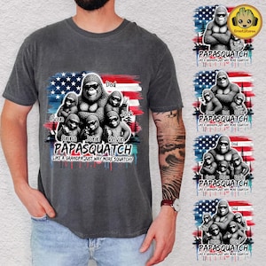 May include: A charcoal gray t-shirt featuring a graphic of a large Bigfoot surrounded by smaller ones, set against a red, white, and blue American flag background. The text reads PAPASQUATCH LIKE A GRANDPA JUST WAY MORE SQUATCHY.