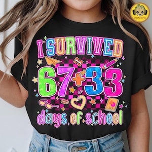 May include: Black t-shirt with a colorful graphic that reads "I Survived 67 + 33 days of school." The design includes a paper airplane, pencil, stars, and other school-themed elements. The text is in various bright colors.