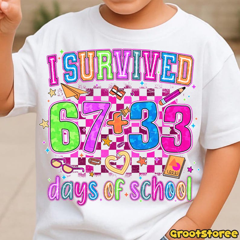May include: White t-shirt with a colorful graphic that reads "I Survived 67+33 days of school." The design includes a paper airplane, pencil, stars, and other school-themed elements. The text is in various bright colors.