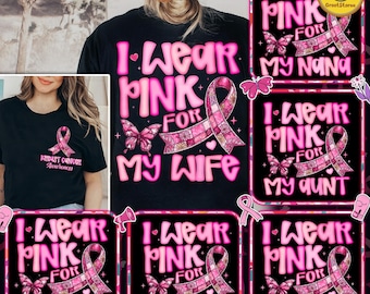 以下が含まれることがあります： ピンク色のテキストとグラフィックが施された黒いTシャツ。「I Wear Pink For」のフレーズに続き、「My Wife」、「My Nana」、「My Aunt」、「My Sister」、「My Friend」、「My Mom」と書かれています。各デザインにはピンクのリボンと蝶が含まれています。