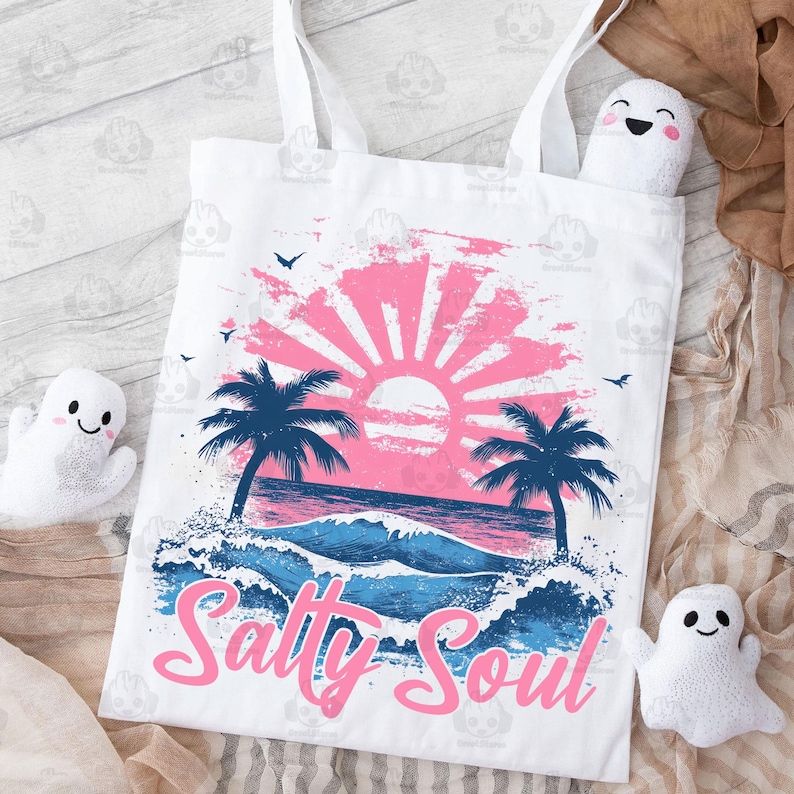 May include: White tote bag with a pink and blue sunset graphic, palm trees, and ocean waves. The text "Salty Soul" is written in pink letters.