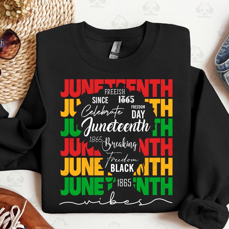 May include: Black sweatshirt with a colorful Juneteenth design. The design includes the words "Juneteenth" in red, green, and yellow, along with the phrases "Freeish Since 1865" and "Celebrate Freedom Day". A silhouette of a person is also included.