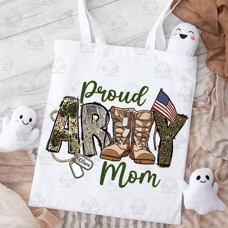 May include: White tote bag with a green, brown, and black camouflage print that says "Proud Army Mom" with a pair of brown military boots and a small American flag.