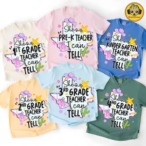 May include: Five short-sleeved t-shirts in cream, pink, blue, yellow, and green. Each features a graphic of the state of Texas with a cowboy hat, boots, a star, and a cactus. The text reads: She's a [Grade] Teacher I can TELL.