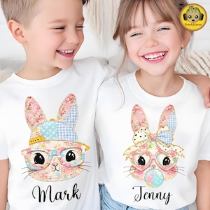 Op de afbeelding: Een set van drie keramische mokken met een gespikkelde, matte afwerking. De mokken zijn in crème, lichtgrijs en donkergrijs. Elke mok heeft een eenvoudig, minimalistisch ontwerp.