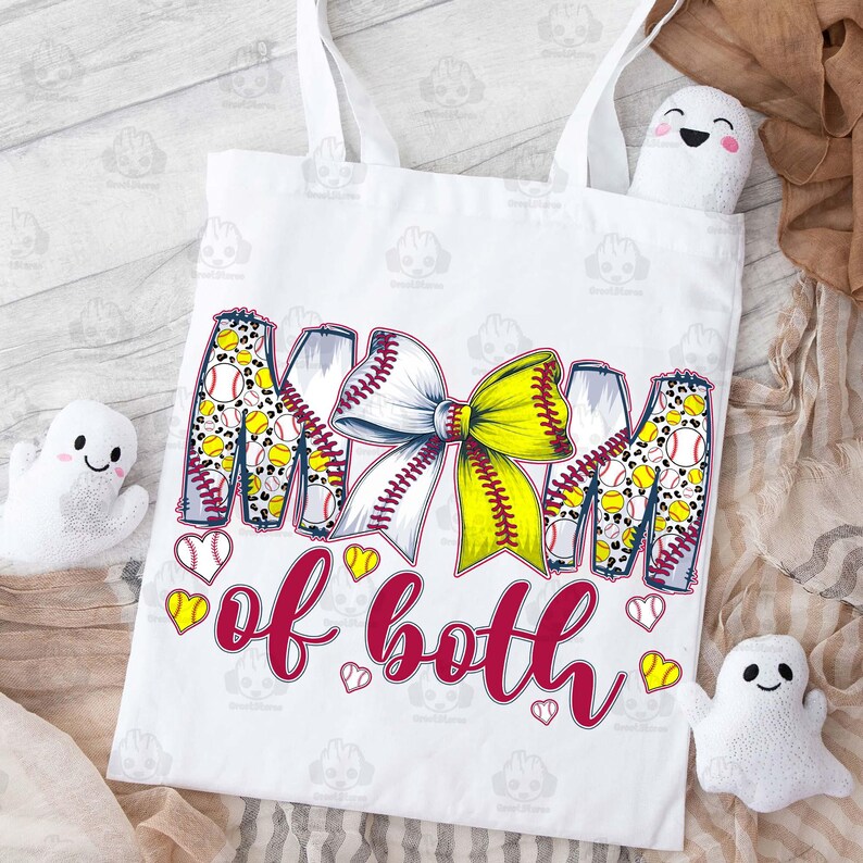 May include: White tote bag with a red and yellow design that says "Mom of both" with a softball and bow graphic.