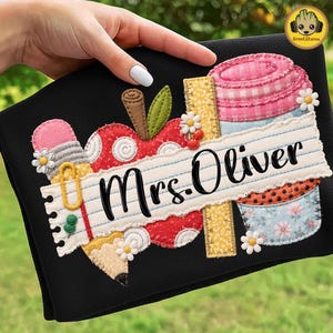 May include: Black teacher-themed design with an apple, pencil, and coffee cup. The design includes the text "Mrs. Oliver" on a lined paper banner. The design is decorated with daisies and a ruler.