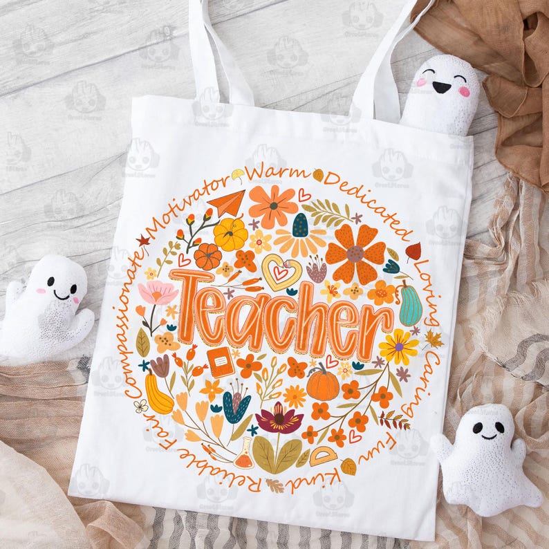 May include: White tote bag with a colorful floral design and the word "Teacher" in orange. The design includes pumpkins, flowers, and the words "Motivator, Warm, Dedicated, Loving, Caring, Fun, Reliable, Fair, Compassionate, Kind." Three small white ghost plushies are also in the image.