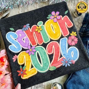 May include: A set of three ceramic mugs with a speckled, matte finish. The mugs are in shades of cream, light gray, and dark gray. Each mug has a simple, minimalist design, perfect for coffee or tea.