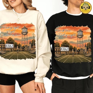 May include: A cream-colored sweatshirt and a black sweatshirt, each featuring a graphic print of a football field at sunset with a water tower labeled 'Petersburg', the number '47567', and the text 'Friday light Night' or 'Small town Friday nights'.
