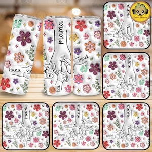 May include: A white tumbler with a floral pattern and the word "mama" at the top. The tumbler features a hand holding three smaller hands with the names "hana", "mark", and "kai" written on each hand.