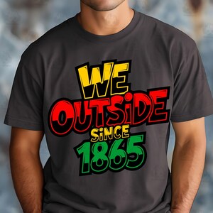 May include: Dark gray t-shirt with the text "WE OUTSIDE SINCE 1865" in yellow, red, green, and black. The shirt has a crew neck and short sleeves. The text is in a bold, stylized font.